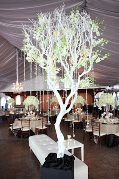 A cloud of white branches, filled with white flowers and crystals make a gorgeous centerpiece Image provided by A Good Affair Event Design